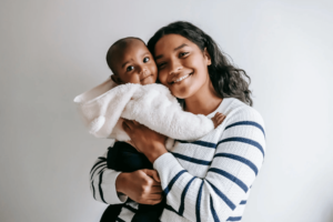 first time mom holding her baby and smiling after she had therapy for anxiety in simi valley